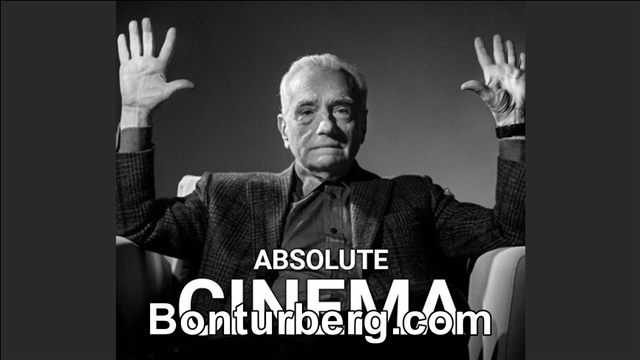 Absolute Cinema meme image: A black-and-white image of a seated man in a suit raising both hands, with the words “ABSOLUTE CINEMA” across the lower half.